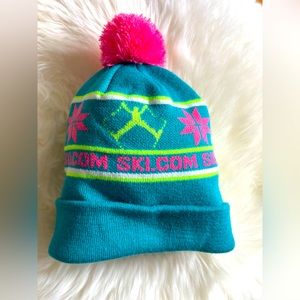 Ski.com knit hat neon colors- skiing. Spread eagle jump